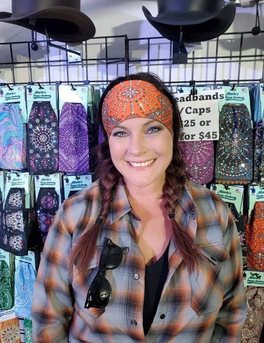 Smiling attendee wearing handcrafted rhinestone headband in natural sunlight